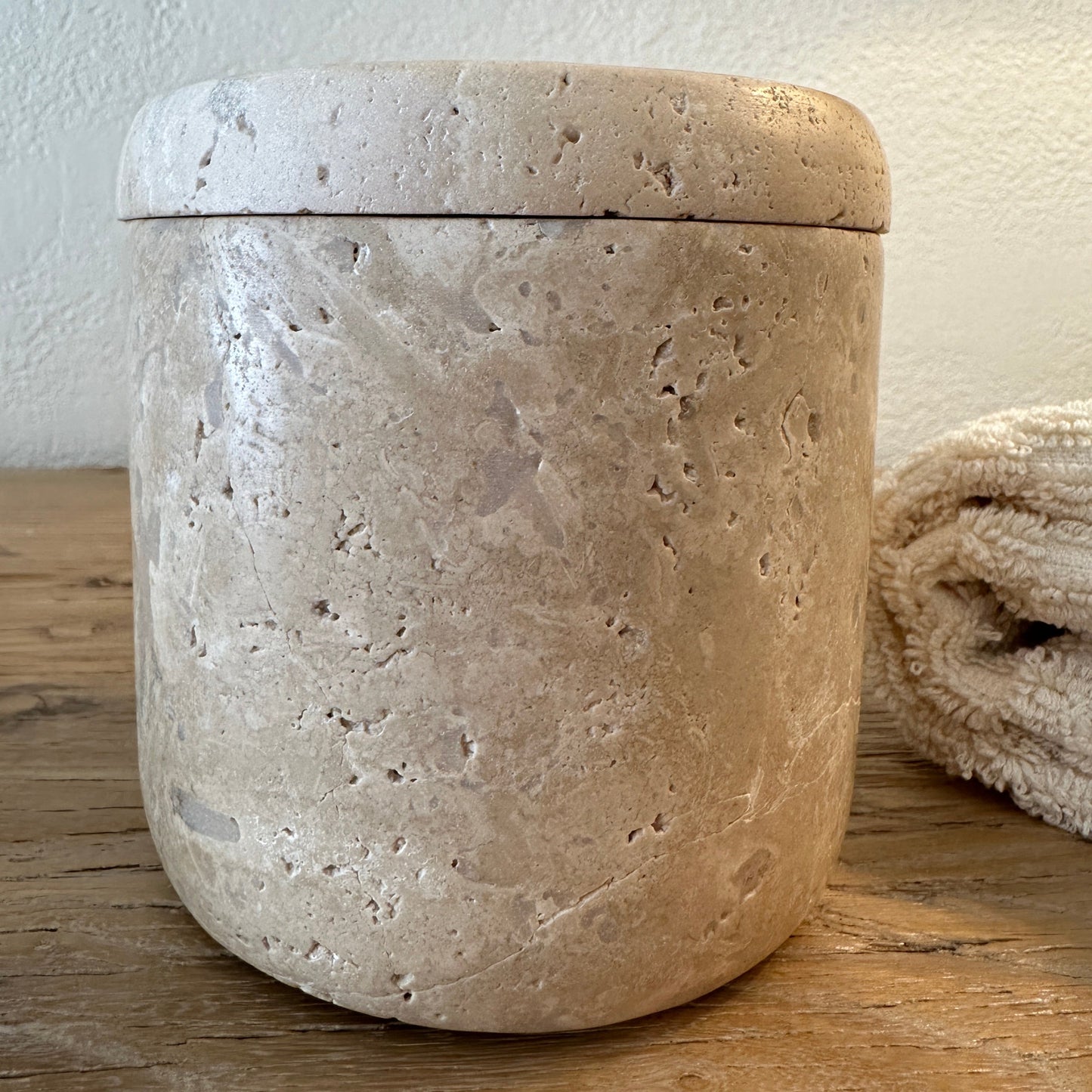 Travertine Marble Canister on wood table.