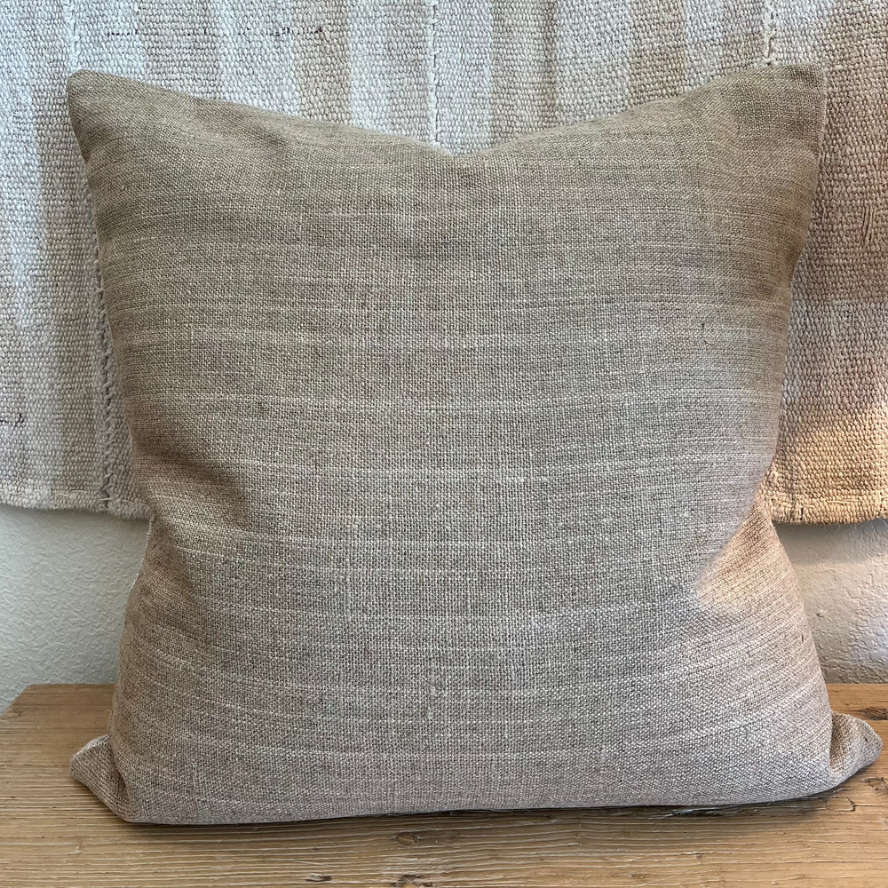 natural colored pillow on wooden bench