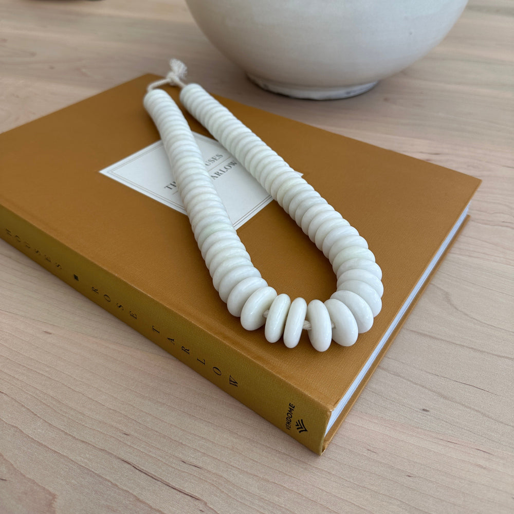 decorative white jade beads on decor book
