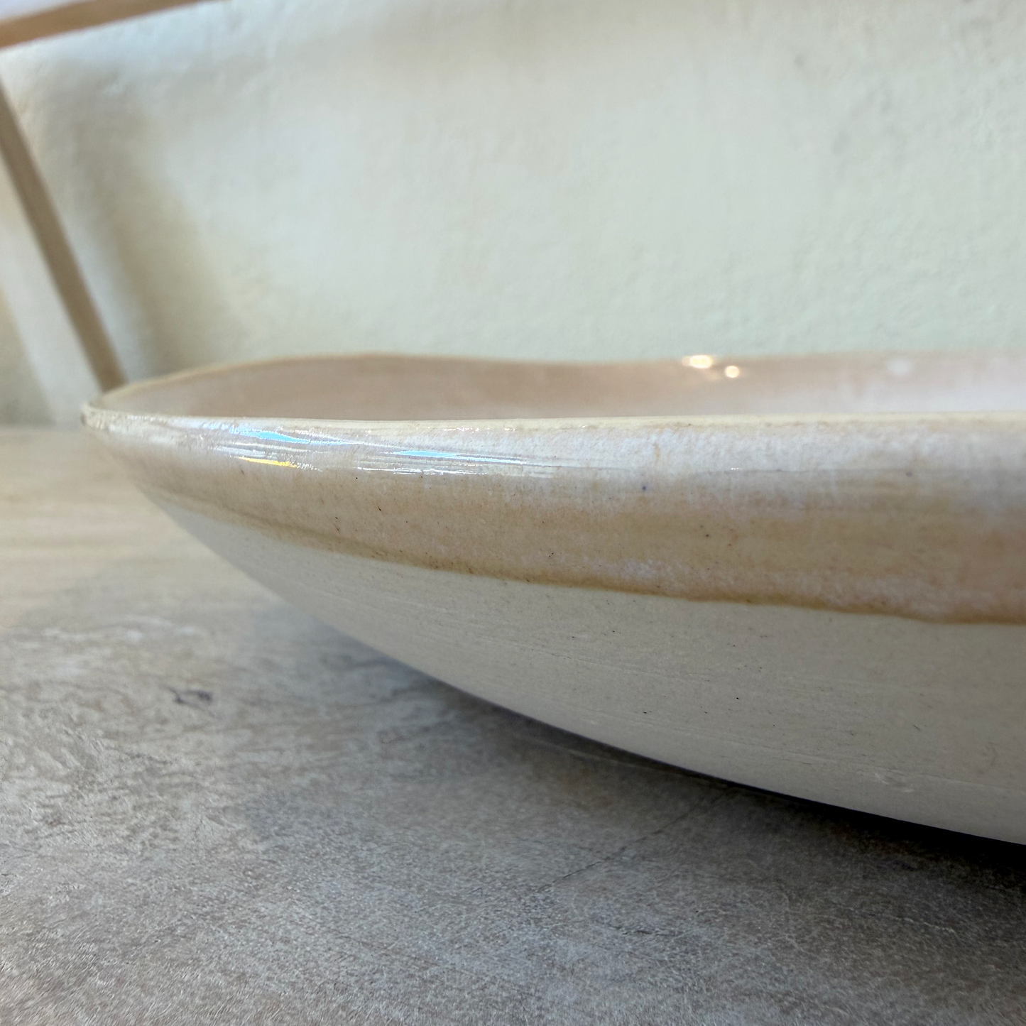 
                  
                    Detail image of the side of a ceramic plater
                  
                