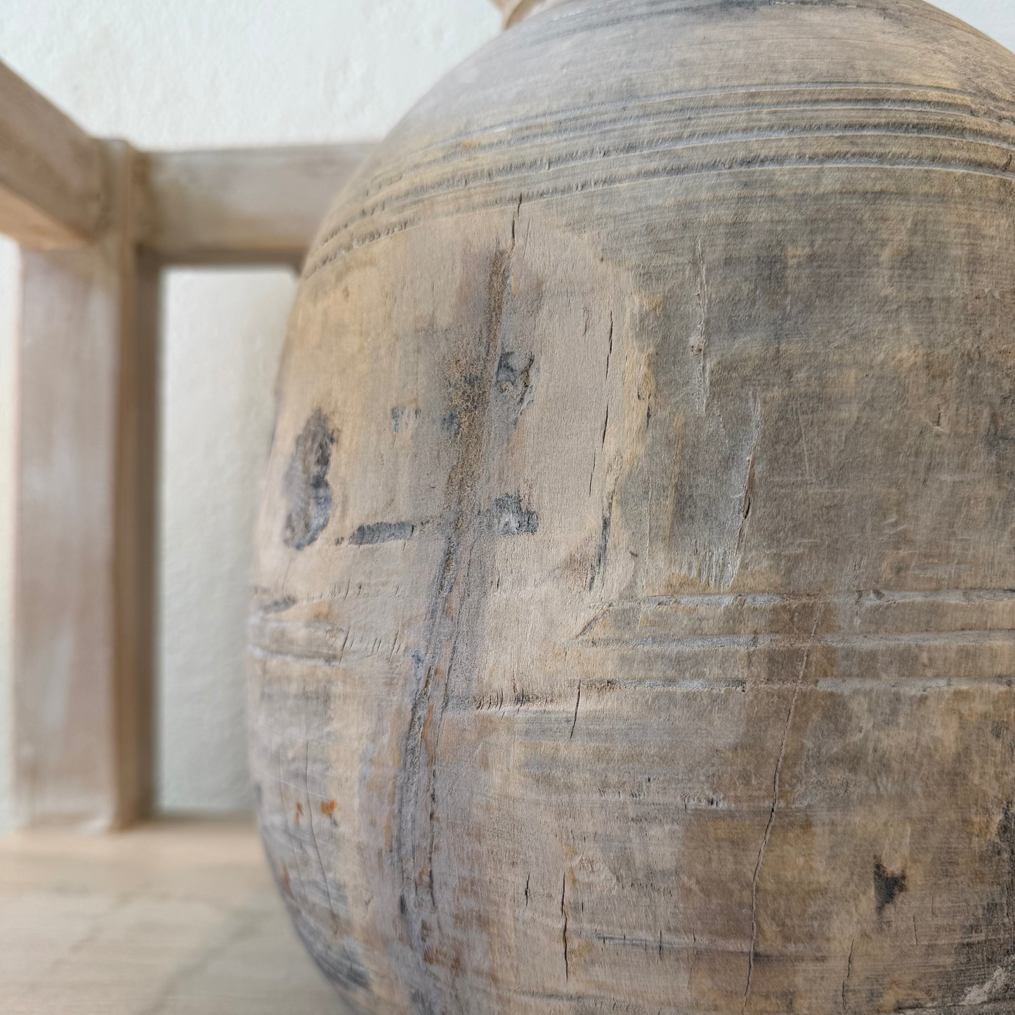 Close-up of a textured wooden vase with visible grain and patterns.