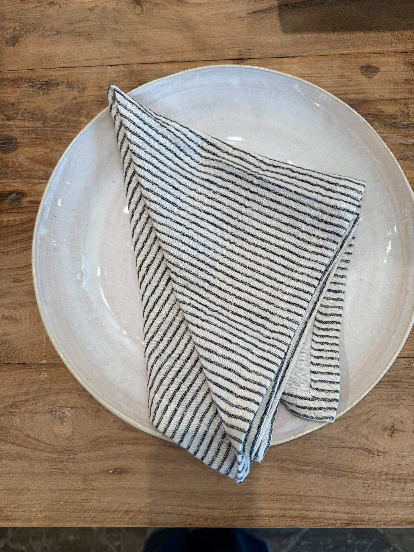 Organic Cotton, Linen Napkin on a ceramic plate on a beautiful wooden table