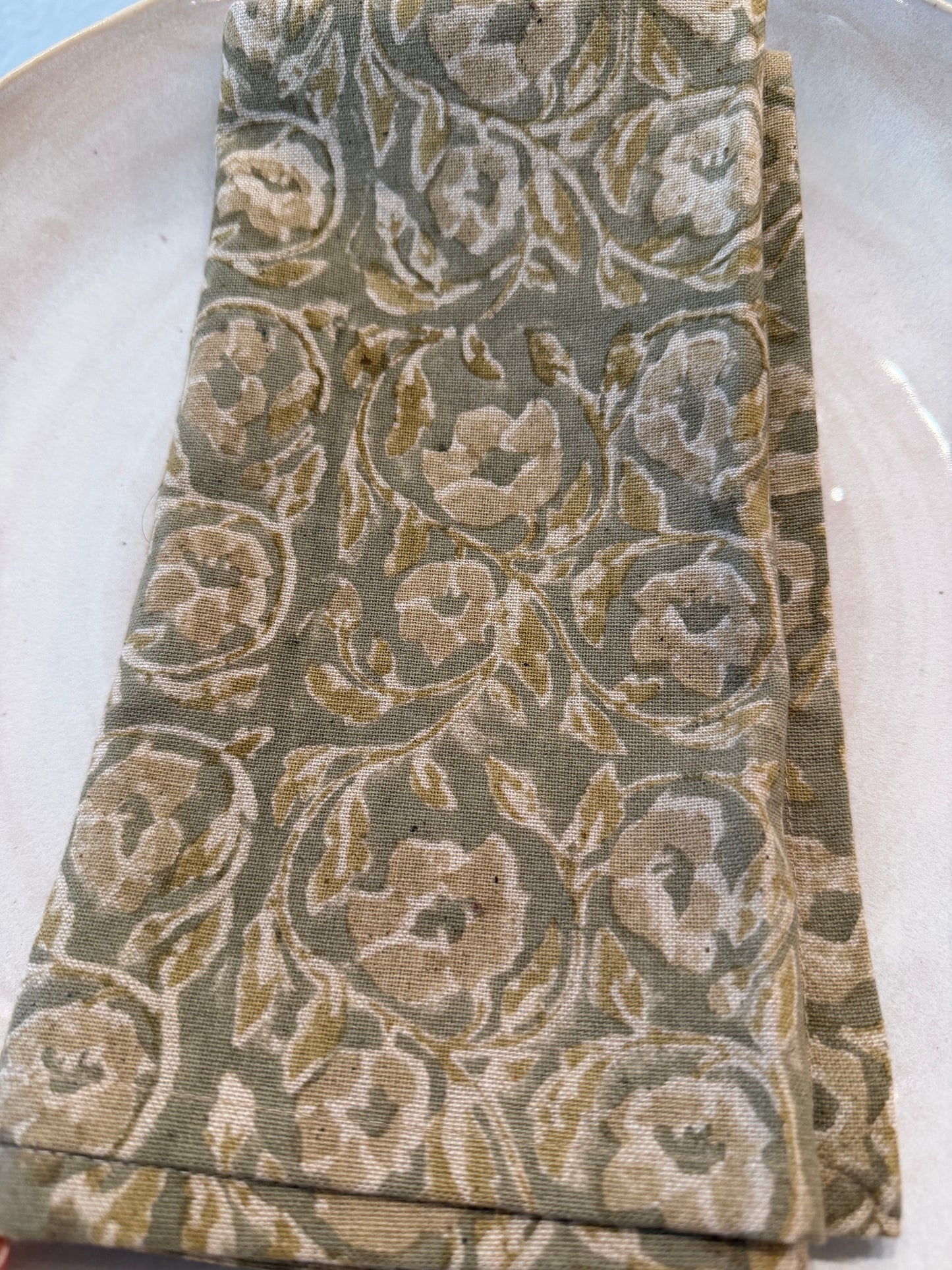 
                  
                    Close-up of floral patterned fabric with brown and beige colors on a gray background
                  
                
