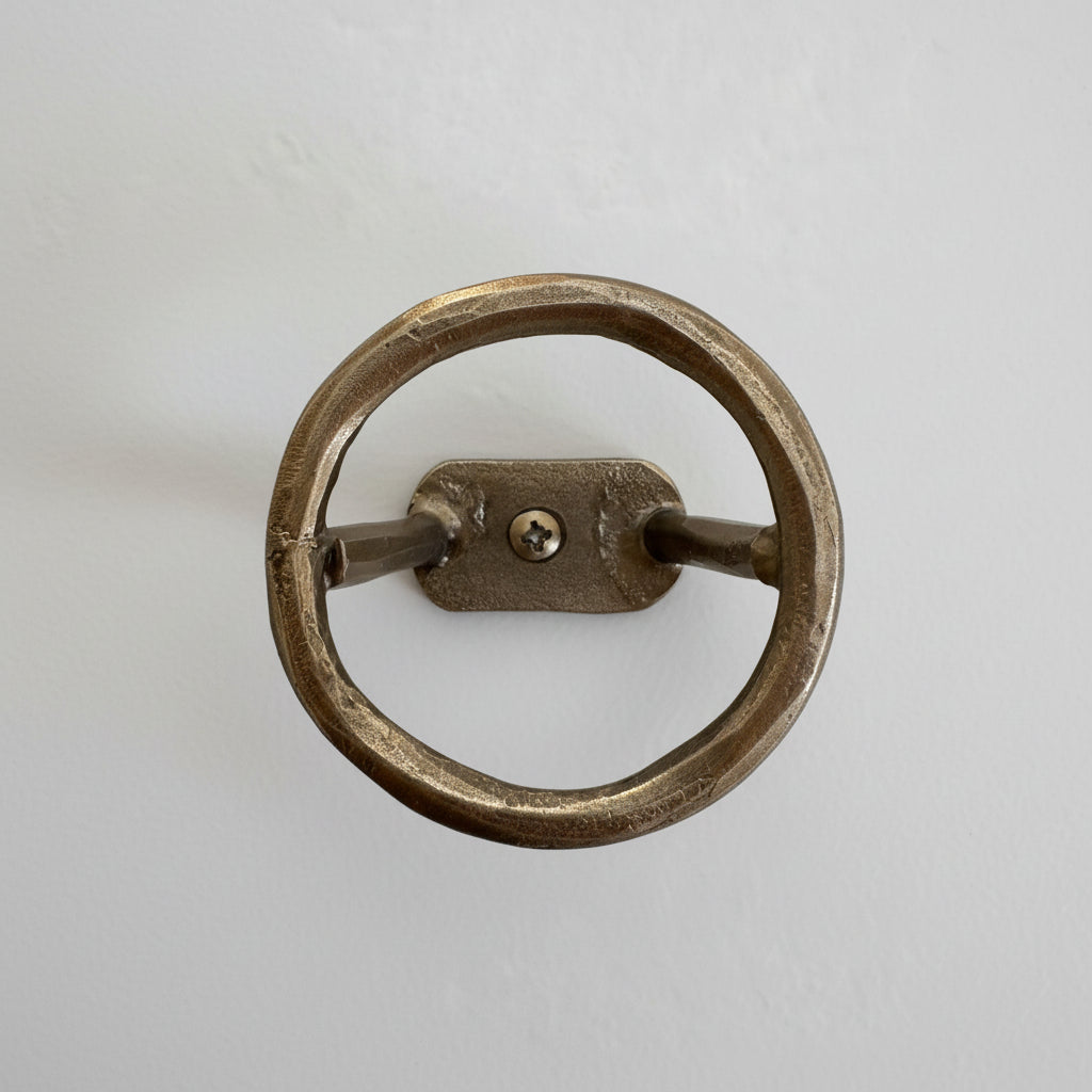 
                  
                    Metal ring handle on a textured white wall
                  
                