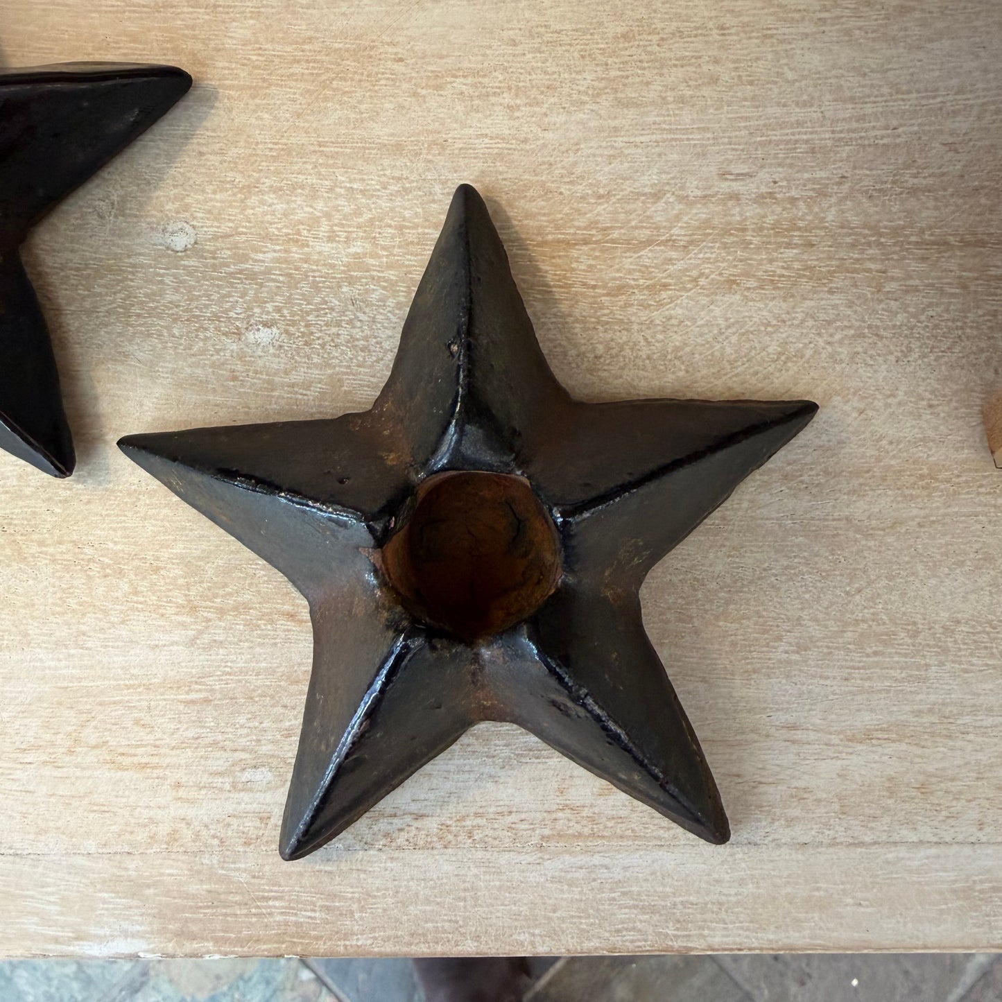 Star-shaped metal object on a wooden surface