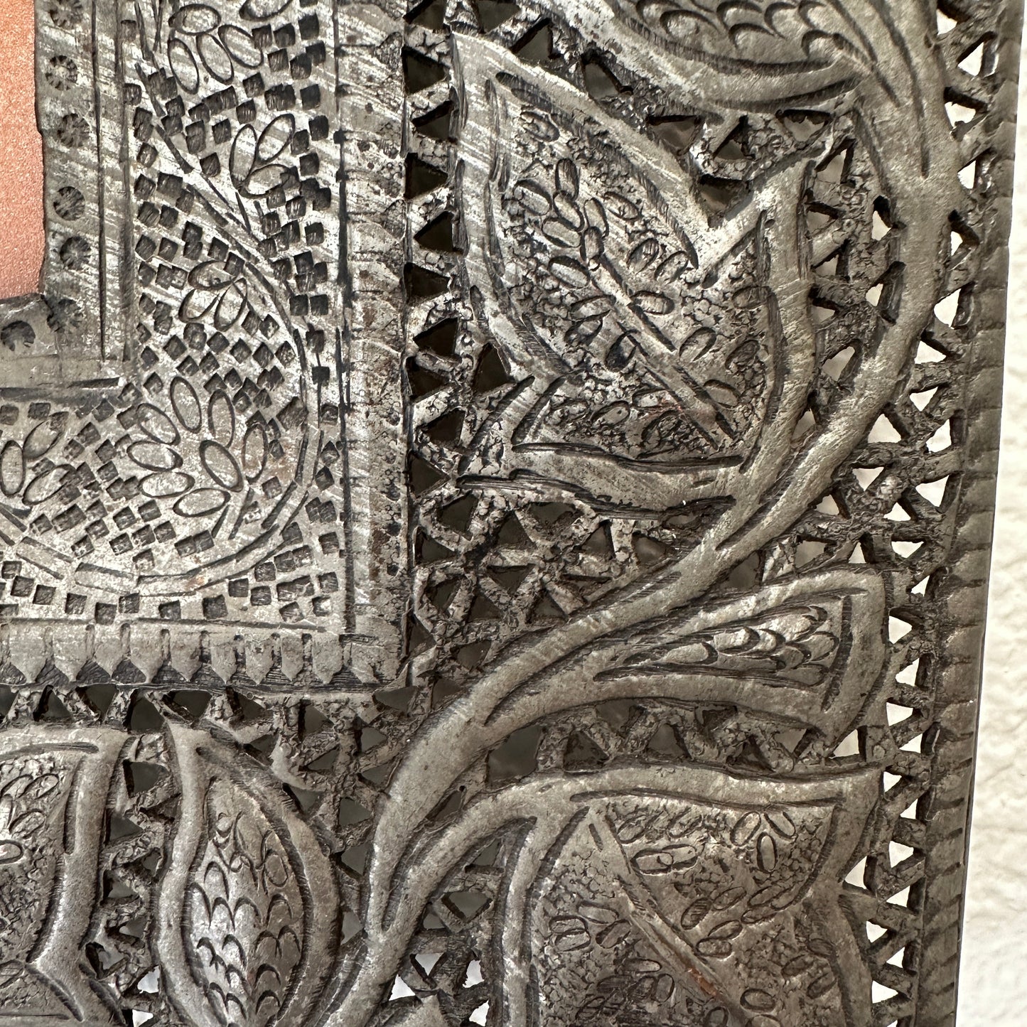 
                  
                    Decorative metal panel with intricate leaf patterns
                  
                