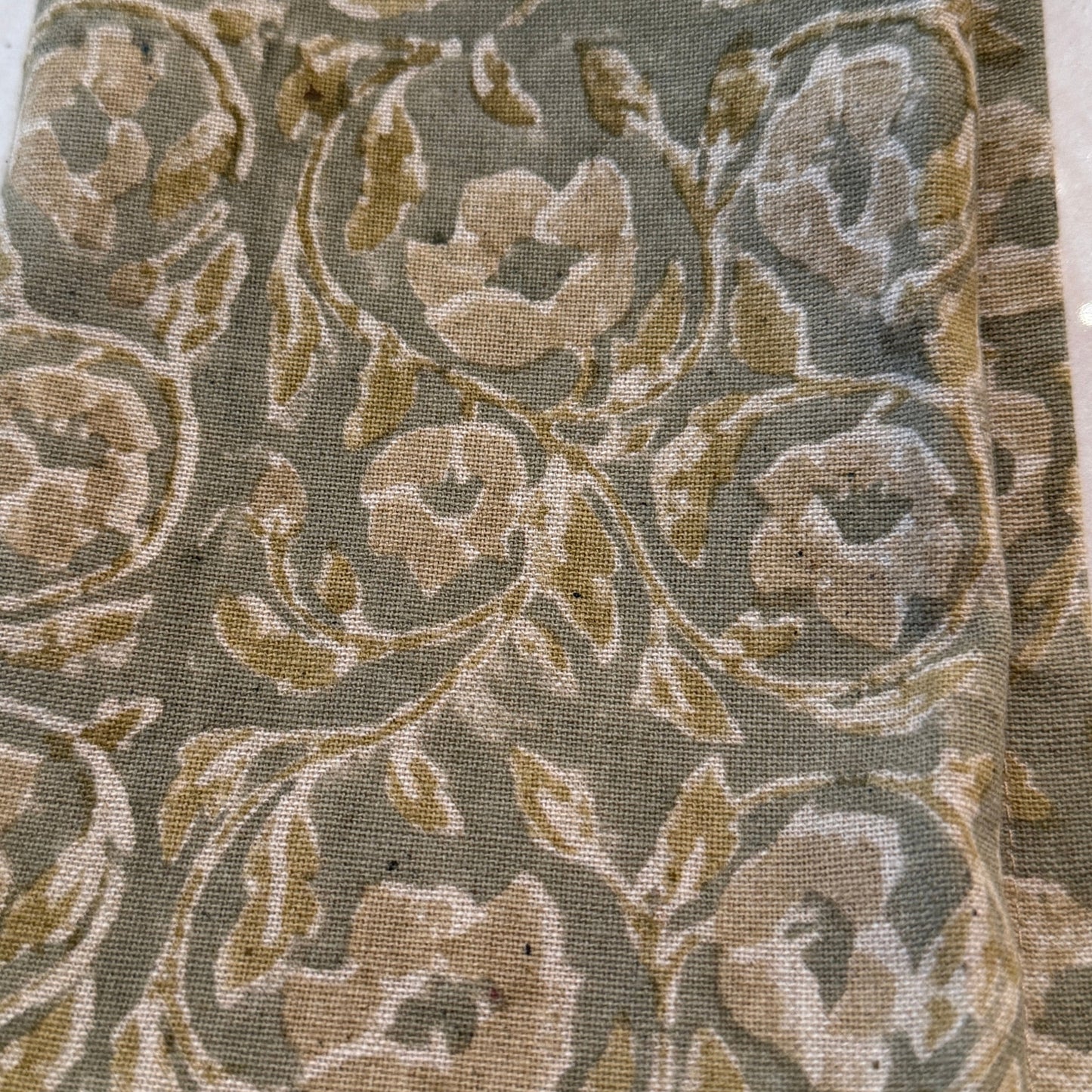 Textile sample with floral pattern on a white background. The beauty of hand made artisan napkin is shown in detail in the petaluma store