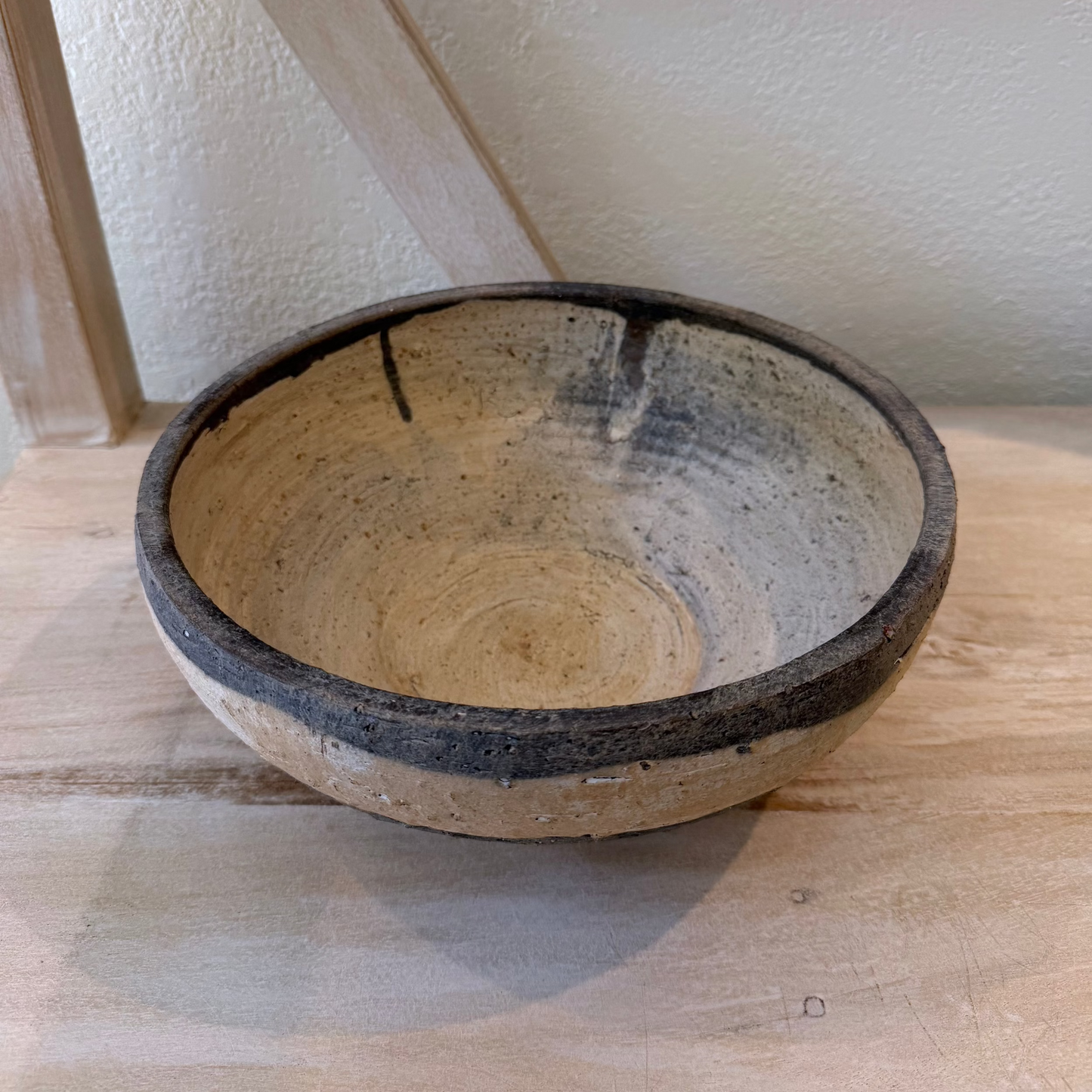 Ceramic bowl on a wooden surface with a neutral background