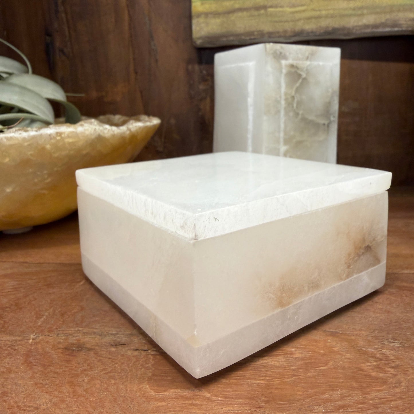 White Stone Lidded box in a dark wood cabinet.