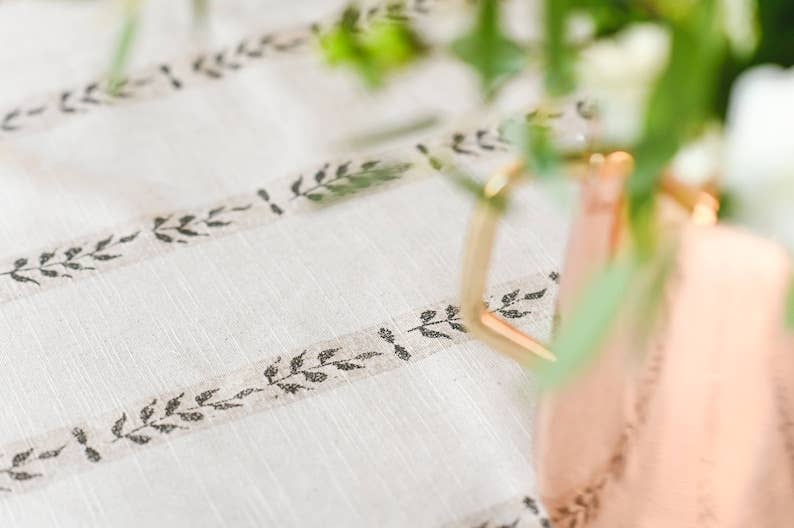 
                  
                    A zoomed in detail of the Walnut table cloth. Showcasing the floral striped print
                  
                