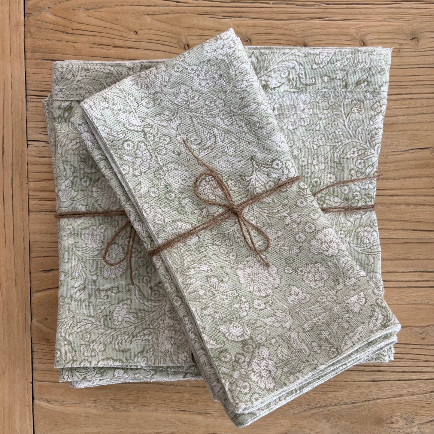 
                  
                    3 Stacks of the mint colored floral napkin. Placed on an elm console. Showcasing the artisans beautiful block printing creation. 
                  
                