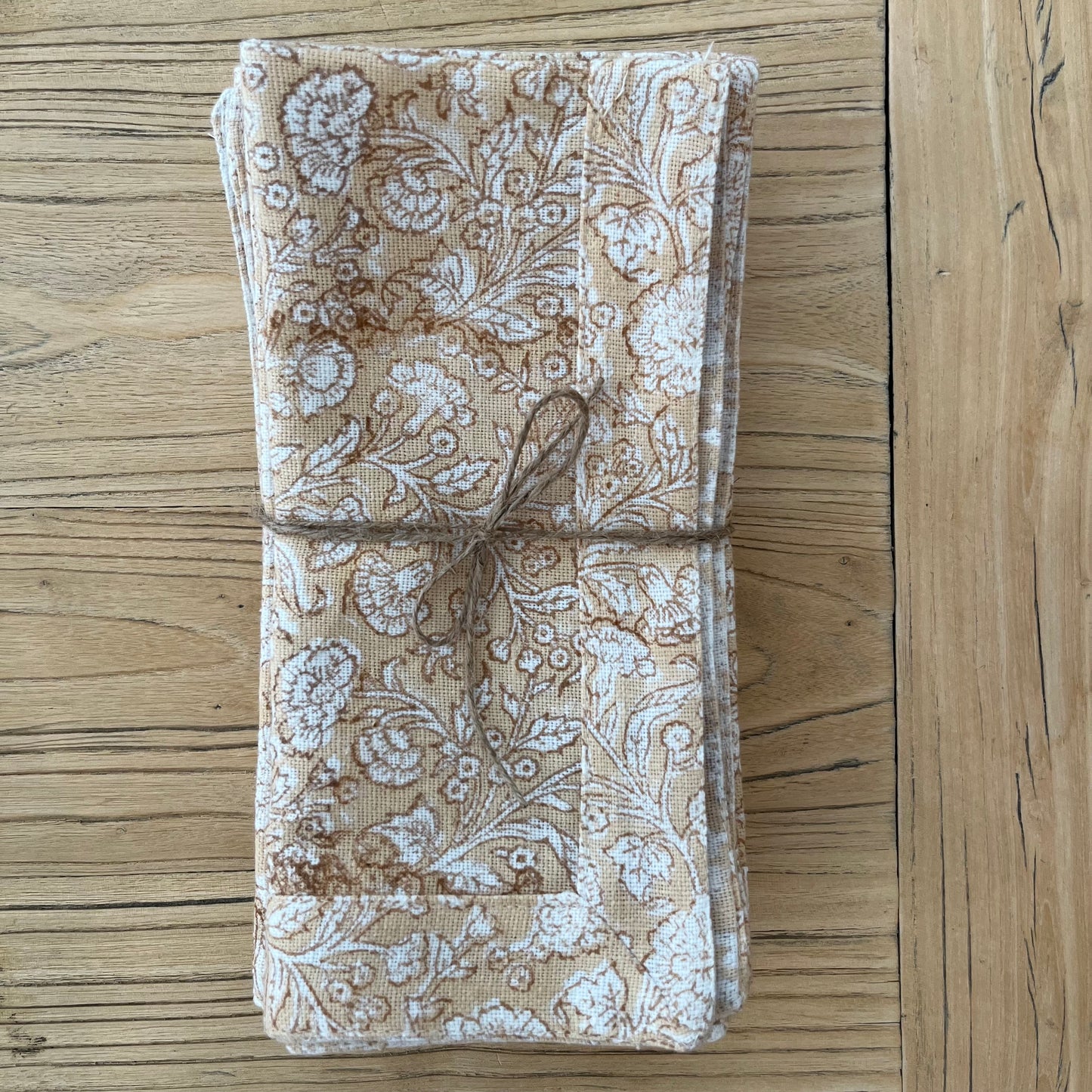 
                  
                    A stunning block printed napkin placed on an elm table. The setting is naturally lit.
                  
                