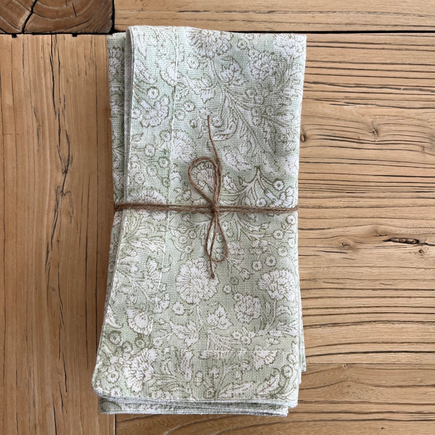 
                  
                    Hand block printed napkin on an elm table
                  
                