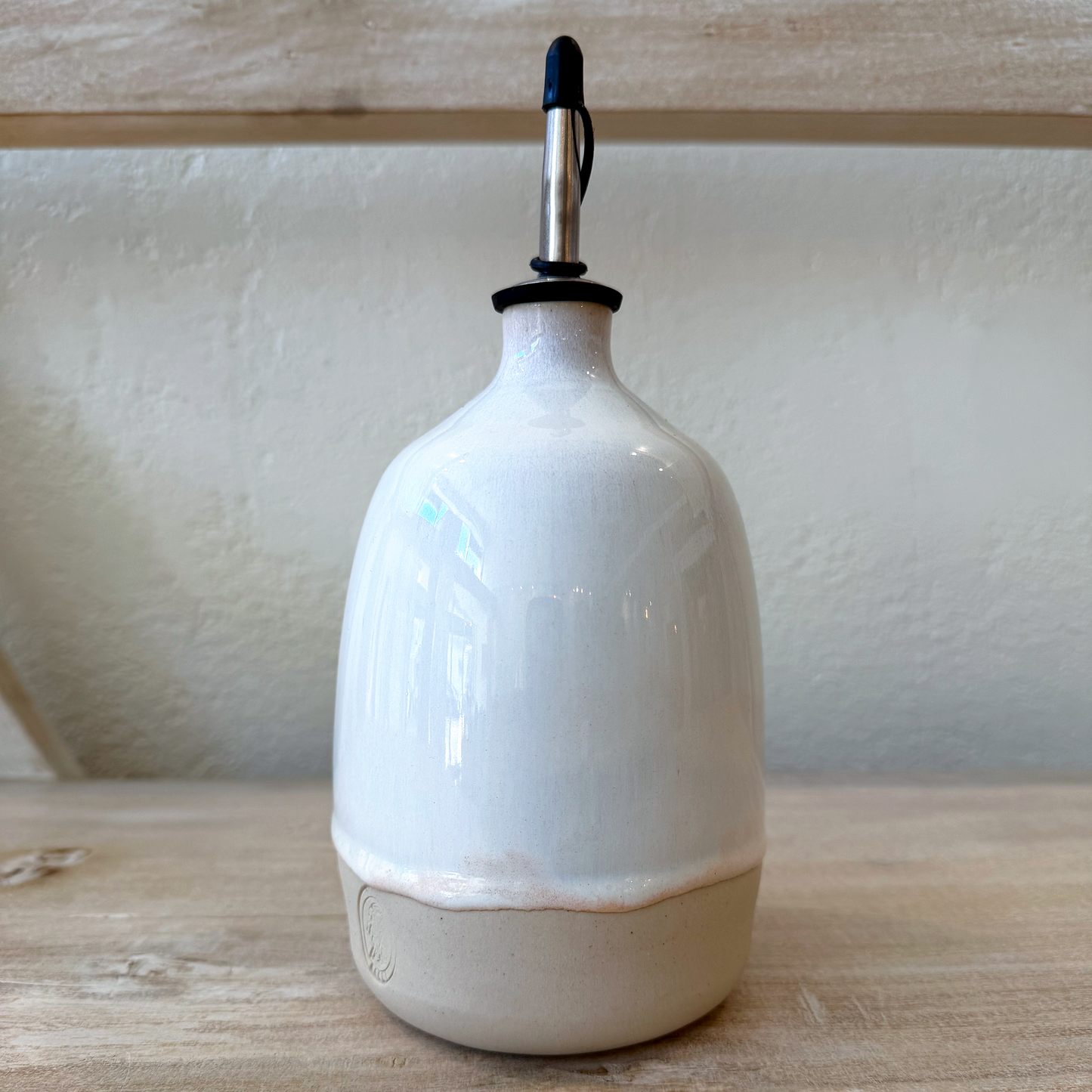 olive oil dispenser on a display shelf 