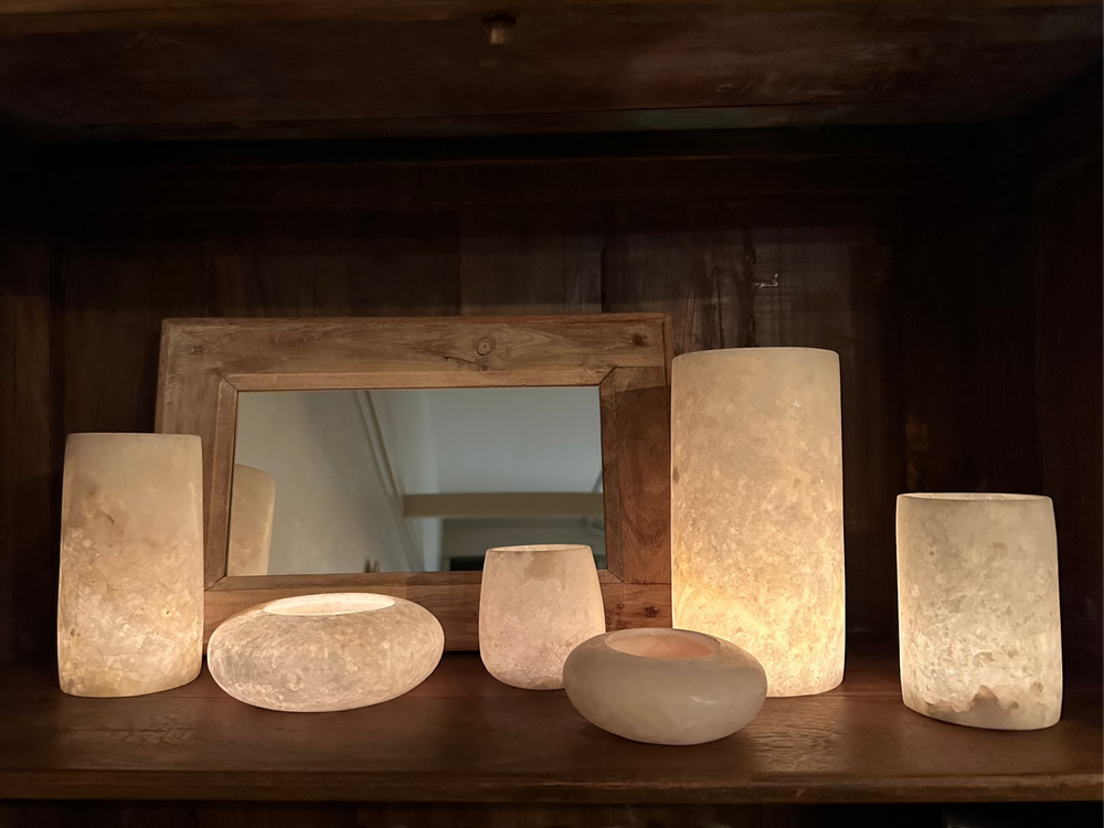 
                  
                    Alabaster Votive lit by a candle glowing like the moon.
                  
                