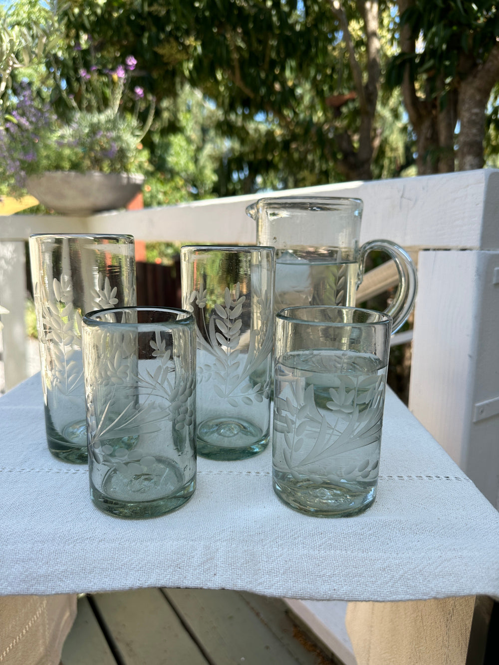 etched glassware placed on out door table