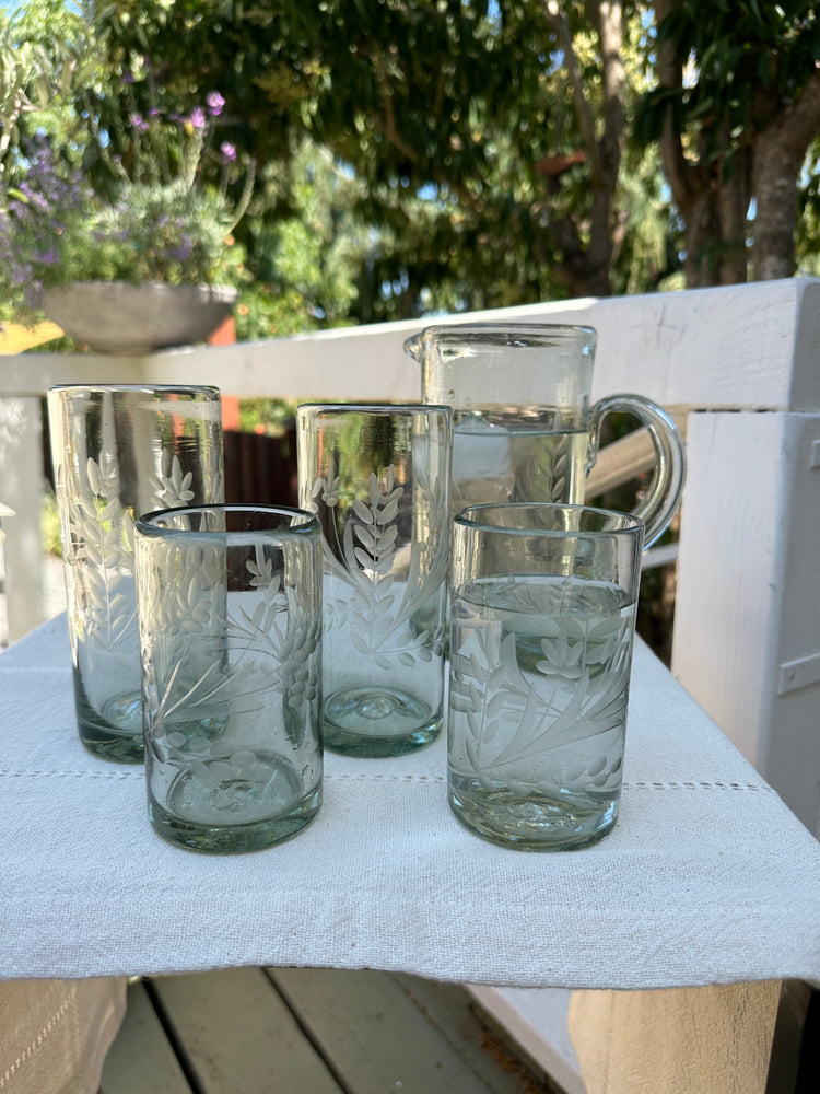 etched glassware placed on out door table