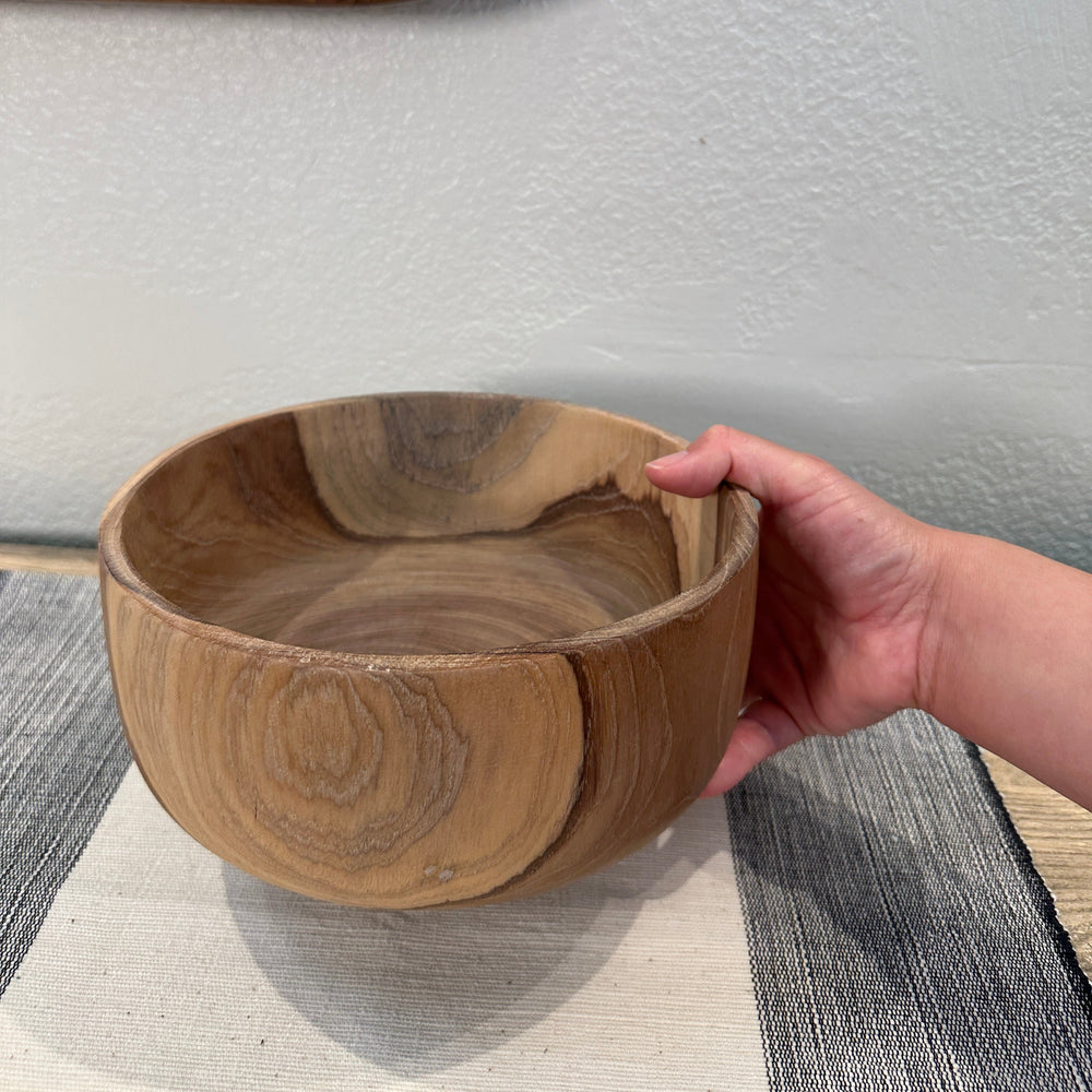 Hand Holding Teak Wood Salad Bowl. 