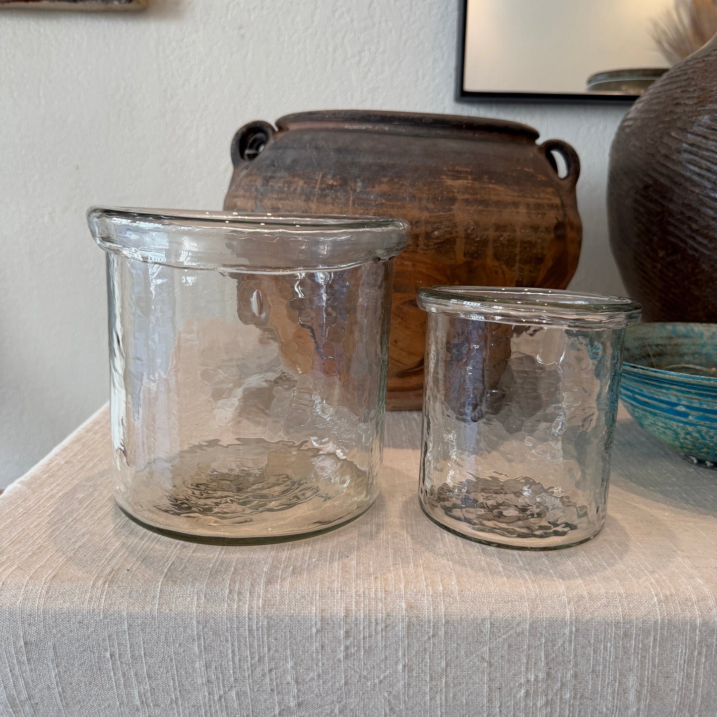Two clear glass vessels with handmade character. 