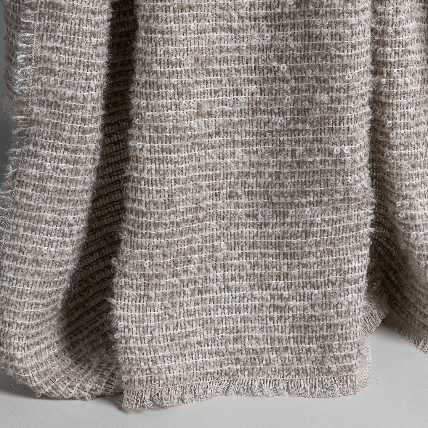 
                  
                    Close-up of a finely woven mohair and linen throw blanket in a neutral color
                  
                