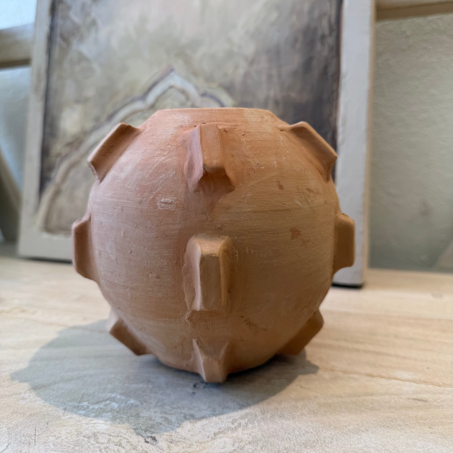 
                  
                    Clay Vase on a wooden surface with a blurred background
                  
                